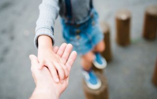 child holding parent hand