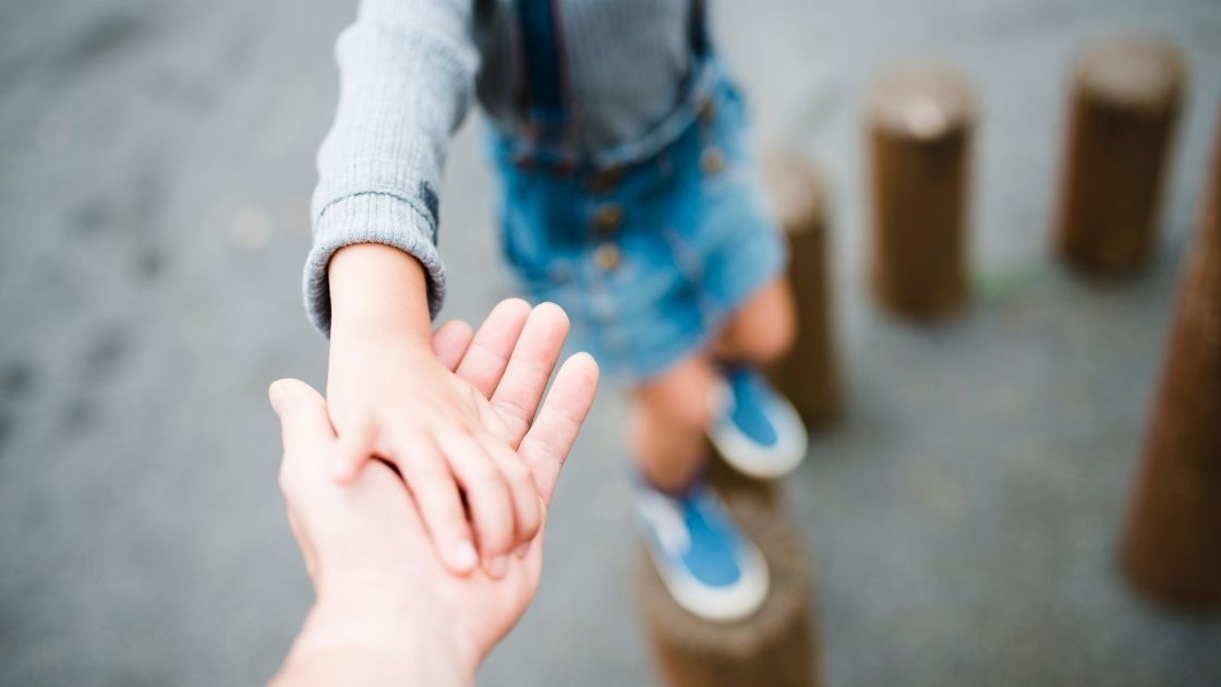 child holding parent hand