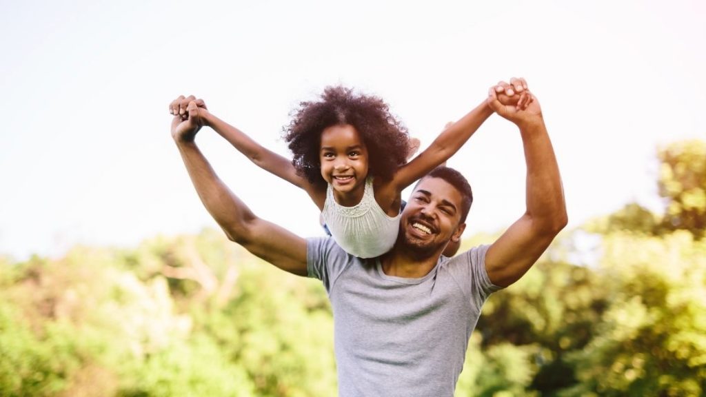 father lifts up daughter